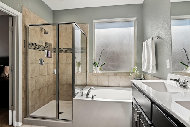 bathroom with shower with separate bathtub and vanity