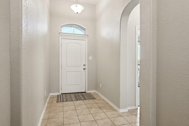 doorway with light tile patterned floors