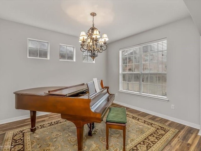 misc room featuring a notable chandelier and hardwood / wood-style flooring