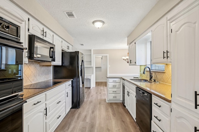 201 Trailwood Dr, Euless, TX 76039 - kitchen with sink, white cabinetry, a textured ceiling, light hardwood / wood-style floors, and black appliances