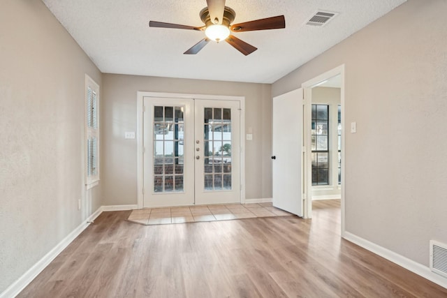 201 Trailwood Dr, Euless, TX 76039 - interior space featuring ceiling fan, a textured ceiling, light hardwood / wood-style floors, and french doors