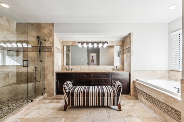 bathroom featuring vanity and shower with separate bathtub