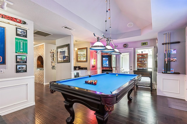 recreation room with dark hardwood / wood-style floors, pool table, and a tray ceiling