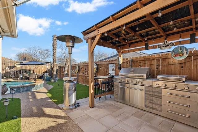 view of patio with exterior kitchen, a gazebo, a fenced in pool, and grilling area