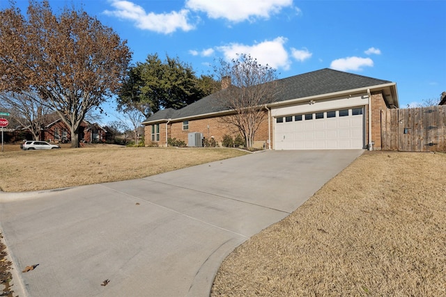 single story home featuring central AC unit, a garage, and a front lawn