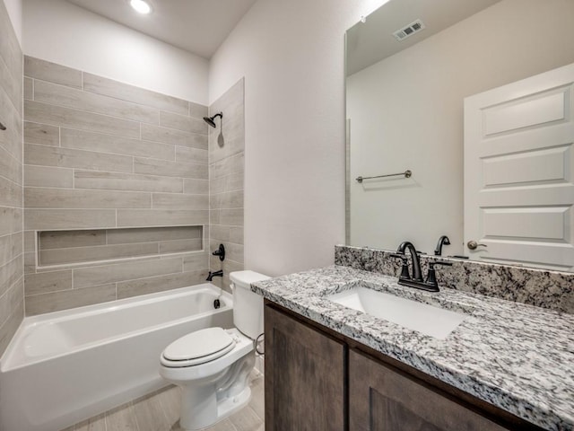 full bathroom with vanity, toilet, and tiled shower / bath