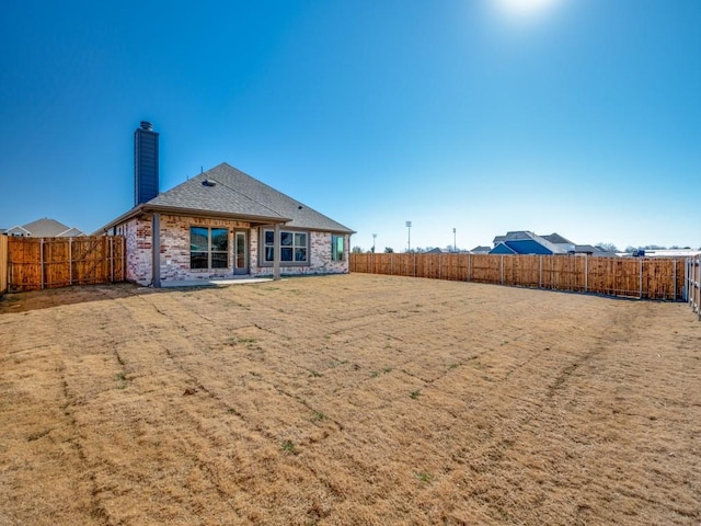 rear view of house with a yard