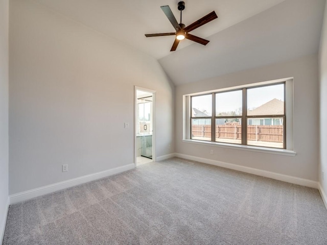 carpeted empty room with vaulted ceiling and ceiling fan