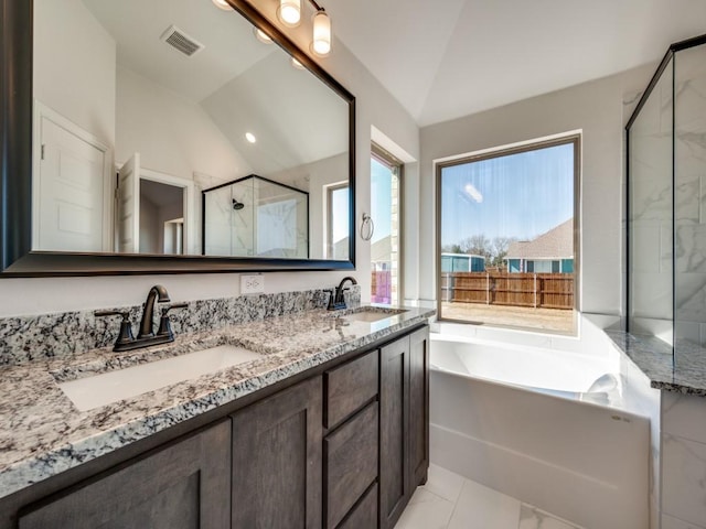 bathroom featuring lofted ceiling, vanity, and shower with separate bathtub