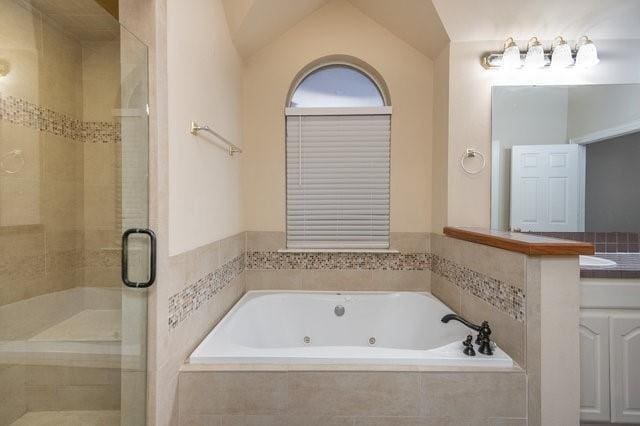 bathroom with independent shower and bath and vaulted ceiling