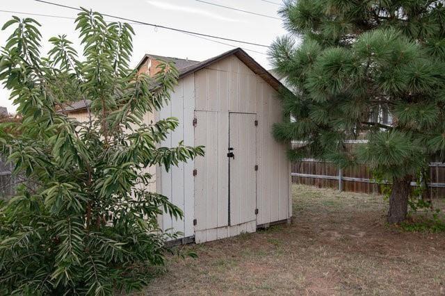 view of shed with fence