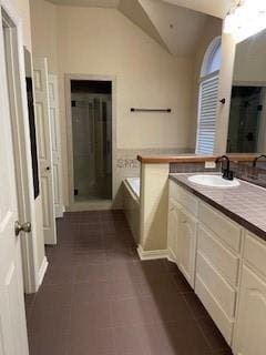 bathroom featuring lofted ceiling, plus walk in shower, and vanity