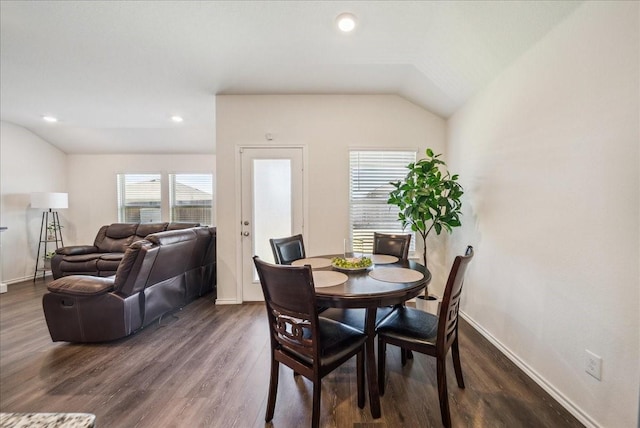 dining space featuring dark hardwood / wood-style floors and vaulted ceiling