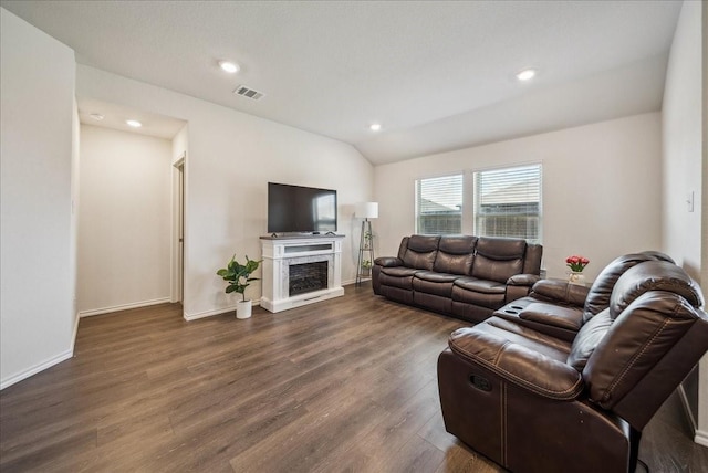 living room with lofted ceiling and dark hardwood / wood-style floors