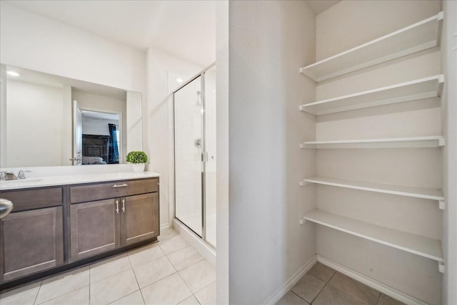 bathroom featuring walk in shower, tile patterned floors, and vanity