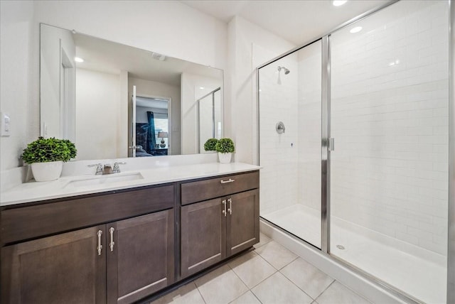 bathroom with walk in shower, tile patterned floors, and vanity