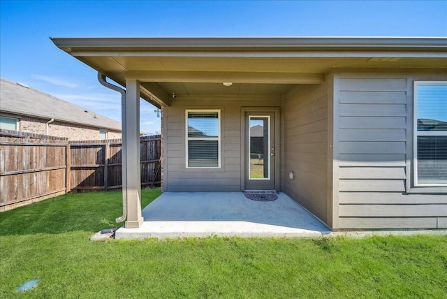 property entrance with a patio and a lawn