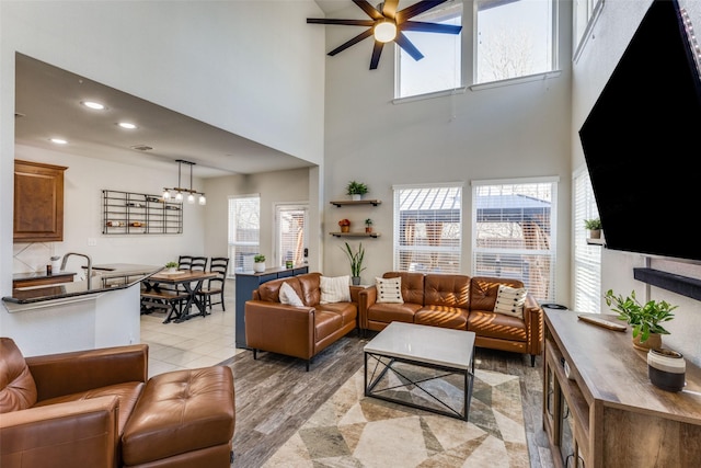 living room featuring ceiling fan with notable chandelier