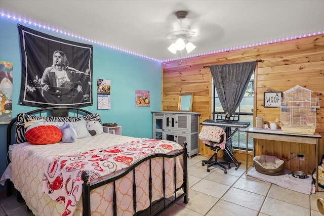 bedroom featuring tile patterned floors and wooden walls