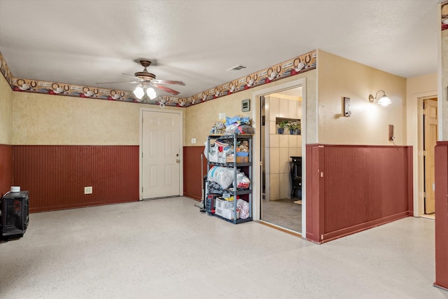 spare room featuring wooden walls and ceiling fan