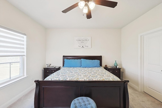 bedroom featuring light carpet and ceiling fan