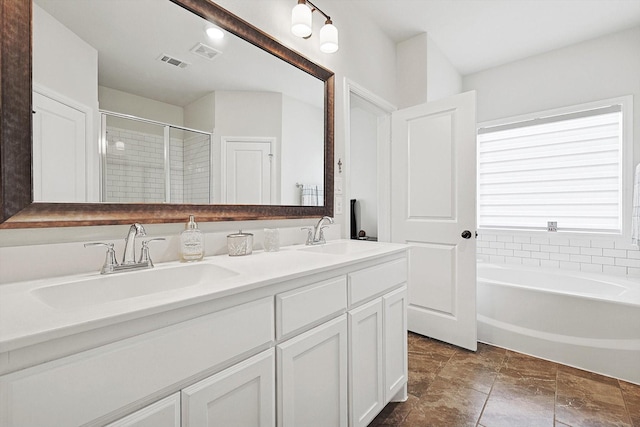 bathroom featuring vanity and shower with separate bathtub