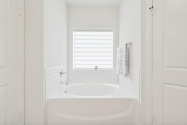 bathroom with a tub to relax in