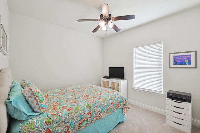 bedroom featuring light colored carpet and ceiling fan