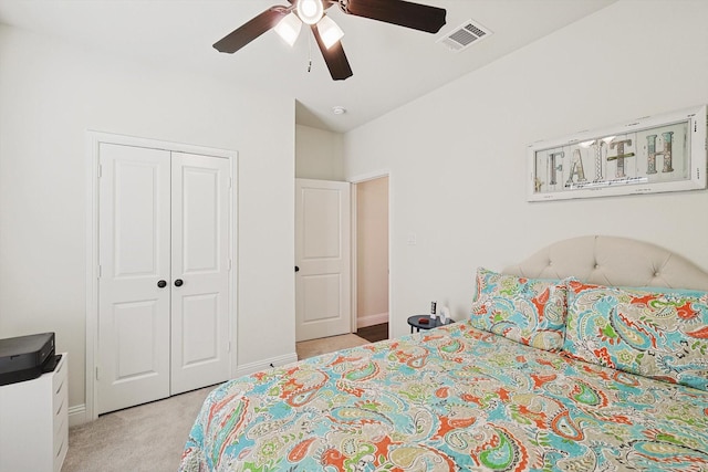 carpeted bedroom featuring a closet and ceiling fan