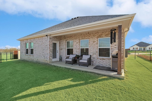 rear view of house featuring an outdoor hangout area, a lawn, and a patio area