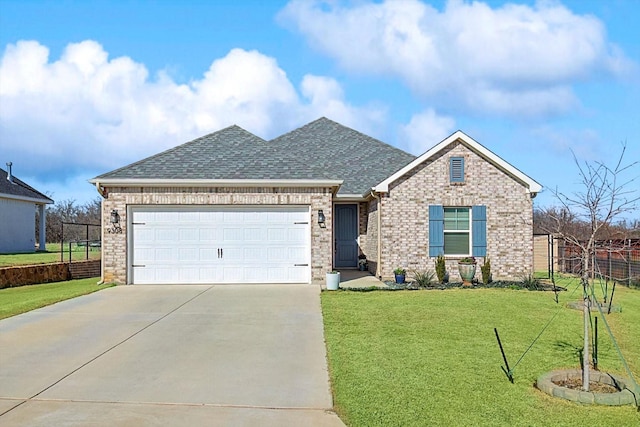 view of front of home featuring a garage and a front lawn