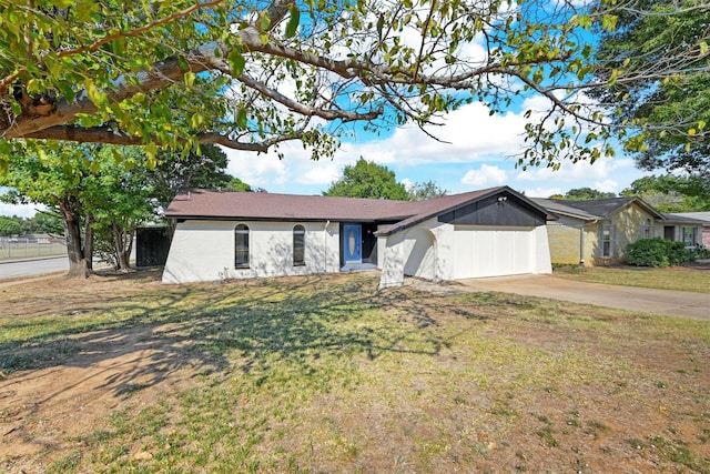 ranch-style house featuring a garage and a front yard