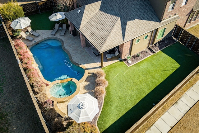 exterior space with an in ground hot tub, a yard, and a patio