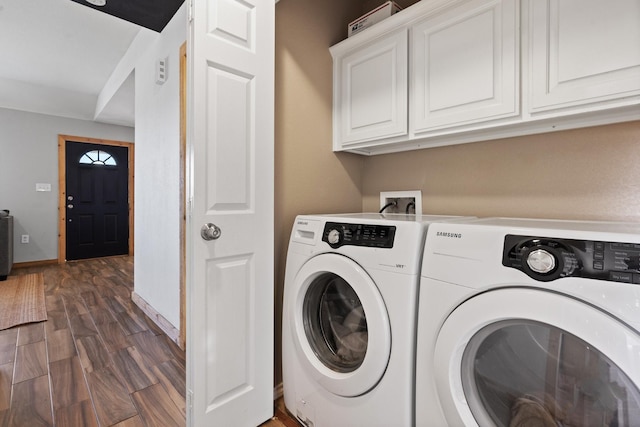 laundry area with cabinets, dark hardwood / wood-style floors, and independent washer and dryer