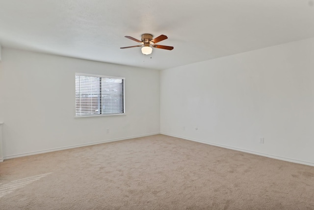 empty room with light colored carpet and ceiling fan