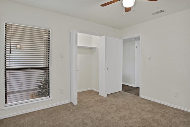 unfurnished bedroom with carpet flooring, ceiling fan, and a closet