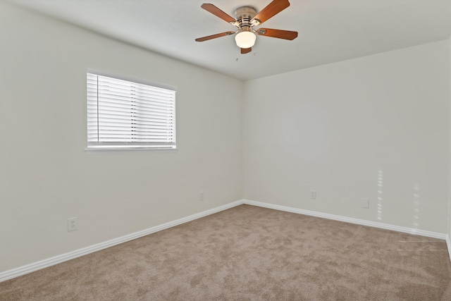 spare room with light carpet and ceiling fan