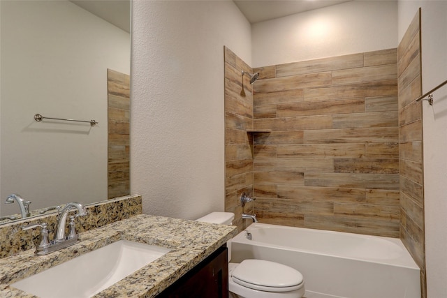 bathroom featuring a textured wall, vanity, toilet, and shower / bathtub combination