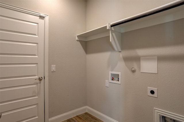 clothes washing area featuring laundry area, hookup for a gas dryer, wood finished floors, hookup for a washing machine, and electric dryer hookup