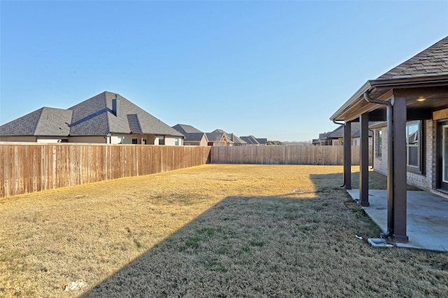 view of yard with a fenced backyard and a patio