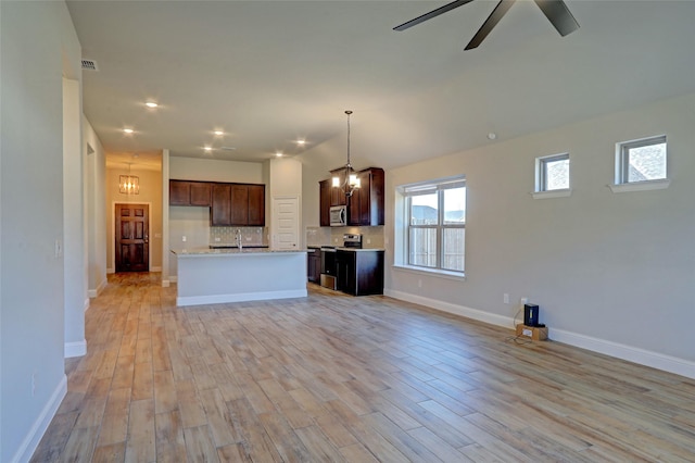 unfurnished living room featuring baseboards, ceiling fan, recessed lighting, and light wood-style floors