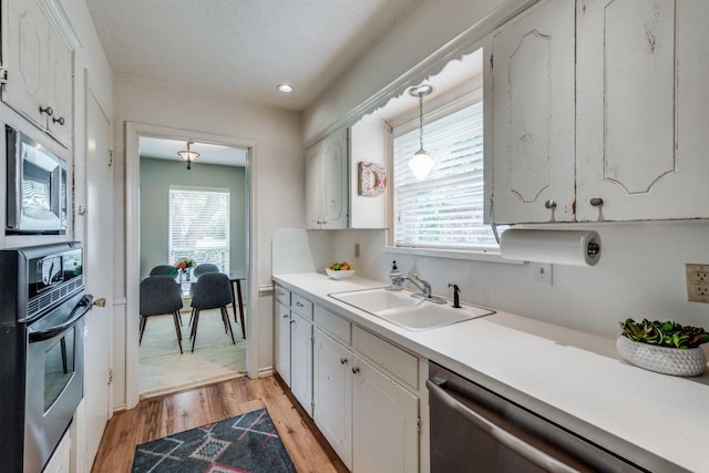 kitchen featuring stainless steel appliances, sink, and white cabinets