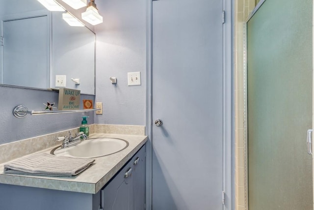 bathroom with vanity and an enclosed shower