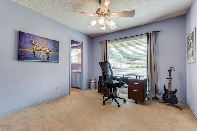 carpeted office with ceiling fan and a textured ceiling