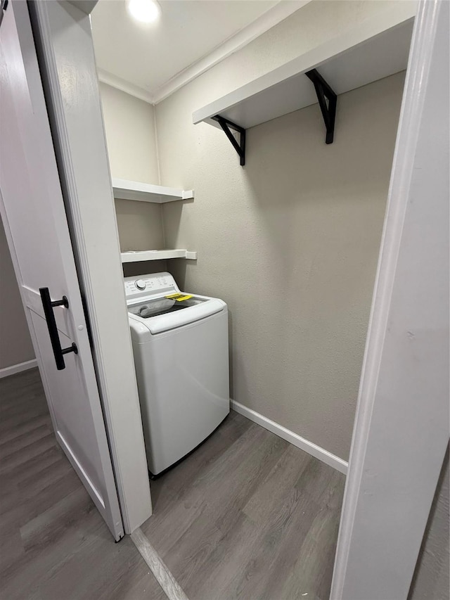 laundry room with washer / clothes dryer and hardwood / wood-style flooring