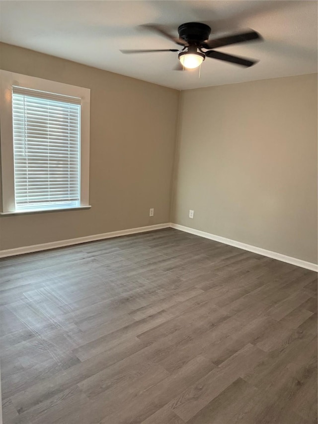 spare room with hardwood / wood-style flooring and ceiling fan