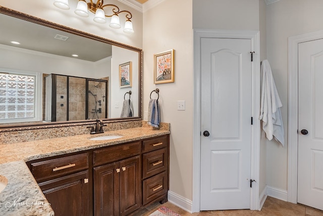 bathroom featuring a shower with door, vanity, and ornamental molding