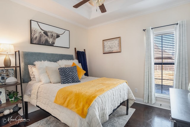 bedroom with dark wood-type flooring, ornamental molding, a tray ceiling, and multiple windows