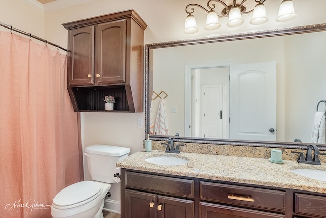 bathroom with vanity, ornamental molding, and toilet