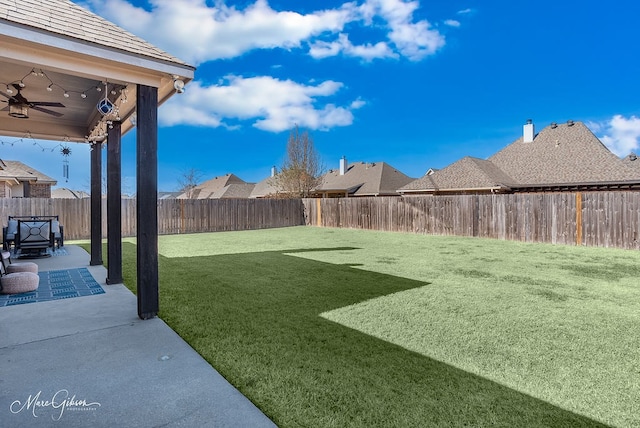 view of yard featuring a patio area and ceiling fan